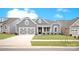 Charming gray home with a two-car garage and beautiful landscaping, set against a bright blue sky at 4440 Moxie Way, Charlotte, NC 28215