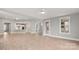 Spacious living room with hardwood floors seamlessly connects to the kitchen, perfect for entertaining at 4440 Moxie Way, Charlotte, NC 28215