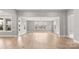 Expansive open living area with hardwood floors and large windows, filling the space with natural light at 4440 Moxie Way, Charlotte, NC 28215