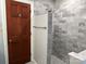 Updated bathroom with a walk-in shower and wood door at 18140 Nantz Rd, Cornelius, NC 28031