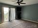 Main bedroom with sliding glass doors leading to a deck and water view at 18140 Nantz Rd, Cornelius, NC 28031