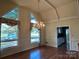 Bright dining room with hardwood floors, chandelier, and large windows at 18140 Nantz Rd, Cornelius, NC 28031