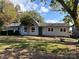 Ranch-style home with gray siding and a well-maintained lawn at 18140 Nantz Rd, Cornelius, NC 28031