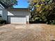 Two-car garage with driveway, surrounded by autumn leaves at 18140 Nantz Rd, Cornelius, NC 28031