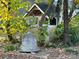 Stone bell and small wooden structure in backyard at 18140 Nantz Rd, Cornelius, NC 28031