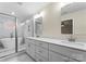 Modern bathroom featuring double sinks, a glass enclosed shower and soaking tub at 1914 Irma St, Charlotte, NC 28216