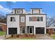 Modern townhomes boast eye-catching curb appeal with stylish exteriors, sleek garage doors, and manicured landscaping at 1914 Irma St, Charlotte, NC 28216