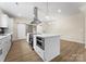 Gourmet kitchen boasts a center island, stainless hood, and sliding barn doors for modern living at 1914 Irma St, Charlotte, NC 28216