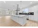 Modern kitchen features a large island, stainless steel appliances, and black backsplash at 1914 Irma St, Charlotte, NC 28216