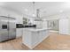 Bright kitchen with stainless steel appliances, white cabinets, and a large center island with pendant lighting at 1914 Irma St, Charlotte, NC 28216