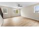 Bright living room with wood-look floors, neutral walls, a ceiling fan, and natural light from the windows at 1914 Irma St, Charlotte, NC 28216