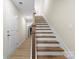 Hallway stairway with modern luxury vinyl floors and neutral walls at 1914 Irma St, Charlotte, NC 28216