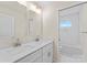 Bright bathroom with double sink vanity, white cabinets, and tile shower at 1916 Irma St, Charlotte, NC 28216