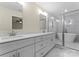 Bathroom with double sink vanity, marble countertops, and a glass-enclosed shower with a soaking tub at 1916 Irma St, Charlotte, NC 28216