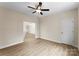 Neutral bedroom with ceiling fan, natural lighting, and adjoining room at 1916 Irma St, Charlotte, NC 28216