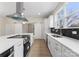 Modern kitchen with stainless steel appliances, sleek white cabinetry, and a center island at 1916 Irma St, Charlotte, NC 28216