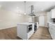 Well-lit kitchen with a central island, stainless steel appliances, and sliding barn doors at 1916 Irma St, Charlotte, NC 28216