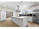 Bright, modern kitchen featuring a large island, stainless steel appliances, and stylish black backsplash at 1916 Irma St, Charlotte, NC 28216