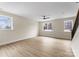 Large living room featuring three large windows, neutral paint and vinyl plank flooring at 1916 Irma St, Charlotte, NC 28216