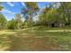 Wooded backyard with a rustic old barn at 5070 Woodleaf Rd, Salisbury, NC 28147