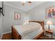 Cozy bedroom with wood frame bed and artwork at 5070 Woodleaf Rd, Salisbury, NC 28147