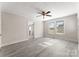 Bedroom with grey flooring, ceiling fan, and access to the bathroom at 5070 Woodleaf Rd, Salisbury, NC 28147