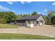 Gray metal building with two garage doors and a long driveway at 5070 Woodleaf Rd, Salisbury, NC 28147