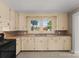 Kitchen with light-colored cabinets, double sink, and a view of the backyard at 5070 Woodleaf Rd, Salisbury, NC 28147