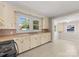 View of kitchen with light cabinets, stove and a view into the dining area at 5070 Woodleaf Rd, Salisbury, NC 28147