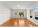 Bright living room with hardwood floors, large windows, and a view of the porch at 5070 Woodleaf Rd, Salisbury, NC 28147