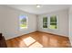 Hardwood floor bedroom with multiple windows and lots of natural light at 5070 Woodleaf Rd, Salisbury, NC 28147