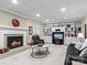 Finished basement with fireplace, built-in shelving, and seating at 806 Lake Mist Dr, Stanley, NC 28164