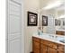 Bathroom with double vanity, wood cabinets, and decorative art at 806 Lake Mist Dr, Stanley, NC 28164