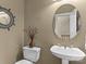 Simple half bathroom with pedestal sink and round mirror at 806 Lake Mist Dr, Stanley, NC 28164