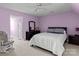 Lavender bedroom with a comfortable bed and rocking chair at 806 Lake Mist Dr, Stanley, NC 28164