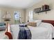 Main bedroom with king-size bed, window seat, and decorative nautical theme at 806 Lake Mist Dr, Stanley, NC 28164