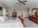 Main bedroom with a king bed, dresser, and ceiling fan at 806 Lake Mist Dr, Stanley, NC 28164