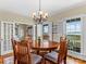 Bright dining room with a round table, chandelier, and water views at 806 Lake Mist Dr, Stanley, NC 28164