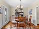 Formal dining room with a round table, chandelier, and hardwood floors at 806 Lake Mist Dr, Stanley, NC 28164