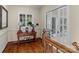 A light-filled hallway with hardwood floors and French doors at 806 Lake Mist Dr, Stanley, NC 28164