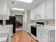 Kitchen features white cabinets, and a view into the adjacent room at 806 Lake Mist Dr, Stanley, NC 28164