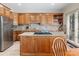 Bright kitchen featuring wood cabinets, granite island, and stainless steel appliances at 806 Lake Mist Dr, Stanley, NC 28164