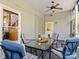 Relaxing screened porch with patio furniture and ceiling fan at 806 Lake Mist Dr, Stanley, NC 28164