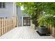 Backyard with a wood deck, a mature tree, and a fully fenced perimeter at 9424 Lexington Cir # F, Charlotte, NC 28213