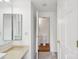Bright bathroom with vanity and view into the toilet and shower area at 9424 Lexington Cir # F, Charlotte, NC 28213