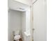 Half bathroom features a toilet, sink, and hardwood floors at 9424 Lexington Cir # F, Charlotte, NC 28213