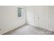 Bedroom features a window and two doors leading to different parts of the house at 9424 Lexington Cir # F, Charlotte, NC 28213
