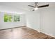 Bedroom with large windows and wood-look flooring at 9424 Lexington Cir # F, Charlotte, NC 28213