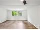 Bedroom with large windows and wood-look flooring at 9424 Lexington Cir # F, Charlotte, NC 28213
