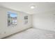 Bedroom featuring carpeted floors, natural light and view of the trees outside at 9424 Lexington Cir # F, Charlotte, NC 28213